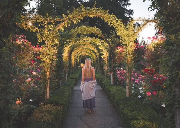 woman walking through butchart gardens in summer